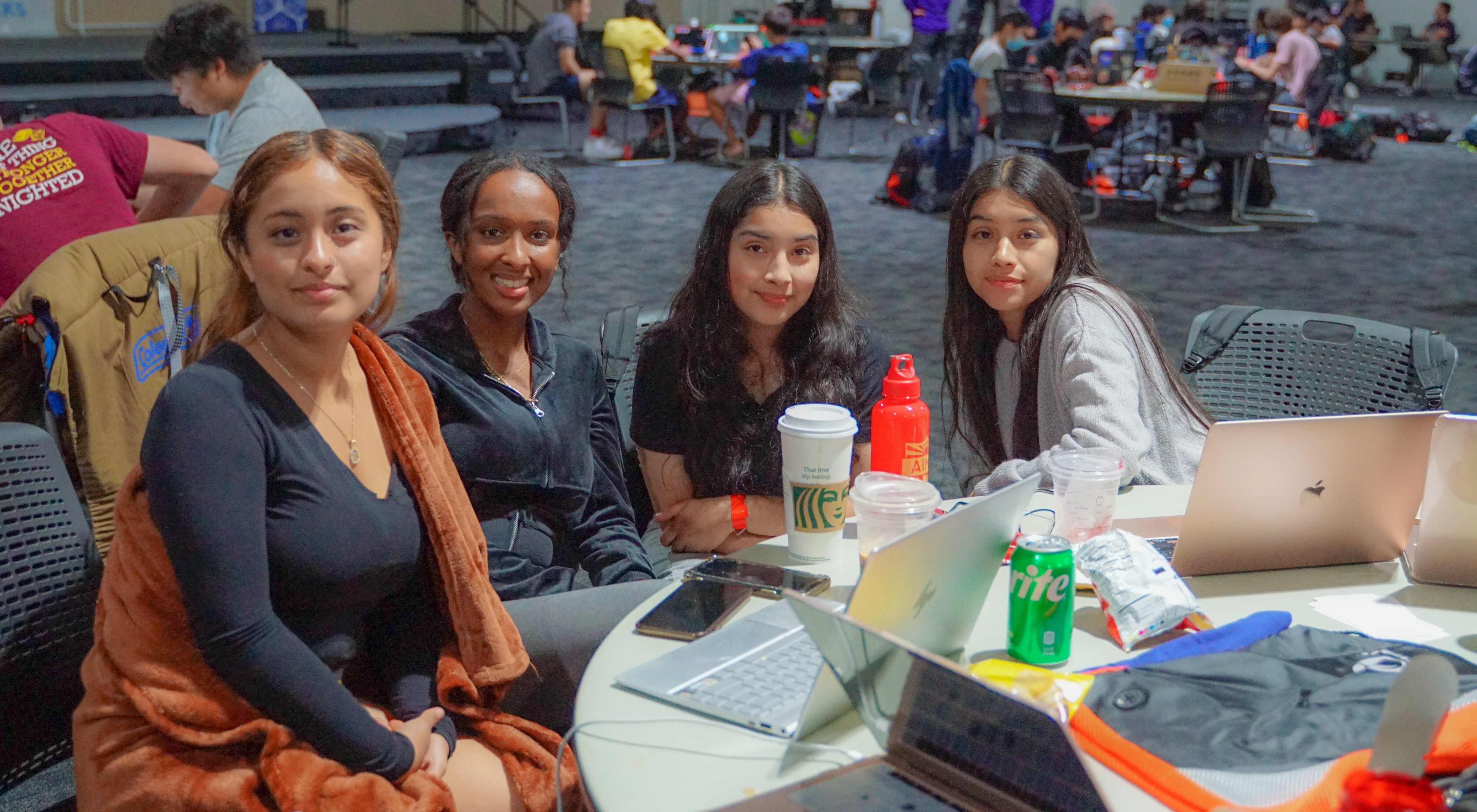 A group of four girls coding on laptops at Los Altos Hacks VI.